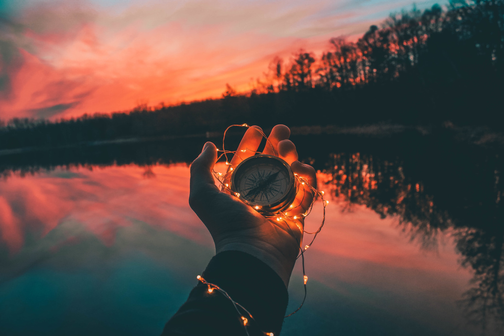 Hand Holding Compass with Lights